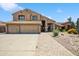 Inviting two-story home with a three-car garage, desert landscaping, and a brick walkway leading to the front entrance at 3905 S Bridal Vail Dr, Gilbert, AZ 85297