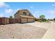 Well-maintained home featuring a three-car garage, desert landscaping, and a secure gate with a spacious driveway at 3905 S Bridal Vail Dr, Gilbert, AZ 85297
