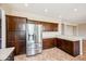 Well-equipped kitchen with stainless steel refrigerator and ample counter space at 3905 S Bridal Vail Dr, Gilbert, AZ 85297