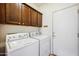 Laundry room with side-by-side washer and dryer and ample cabinet space for storage at 3905 S Bridal Vail Dr, Gilbert, AZ 85297
