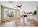 Open concept living area with tile flooring flows into the kitchen and offers views of the outdoor patio at 3905 S Bridal Vail Dr, Gilbert, AZ 85297