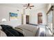 Comfortable main bedroom with access to the main bath, balcony, and ample natural light at 3905 S Bridal Vail Dr, Gilbert, AZ 85297