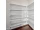Walk-in pantry featuring multiple shelves, hardwood floors at 3905 S Bridal Vail Dr, Gilbert, AZ 85297
