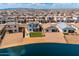 Picturesque aerial view of community with lake and expansive desert landscape surrounding modern homes at 40445 W Bravo Dr, Maricopa, AZ 85138