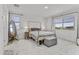 Airy bedroom with natural light, neutral decor, and a cozy bed setting at 40445 W Bravo Dr, Maricopa, AZ 85138