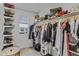 Organized walk-in closet featuring shelves and hanging rods, offering ample storage space for clothing and accessories at 40445 W Bravo Dr, Maricopa, AZ 85138