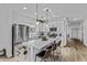 Bright kitchen featuring a large island with seating, pendant lighting, and stainless steel appliances at 40445 W Bravo Dr, Maricopa, AZ 85138