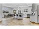 Spacious eat-in kitchen with tile flooring, stainless appliances, an island with seating, and a dining table at 40445 W Bravo Dr, Maricopa, AZ 85138