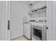 Efficient laundry room featuring side-by-side appliances and ample shelving at 40445 W Bravo Dr, Maricopa, AZ 85138