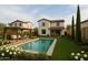Inviting backyard with a sparkling pool, a pergola-covered seating area, and lush landscaping at 40445 W Bravo Dr, Maricopa, AZ 85138