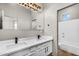 Modern bathroom with double sinks, quartz countertops, and sleek, black fixtures at 4121 E Patrick St, Gilbert, AZ 85295