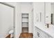 Bright bathroom featuring a toilet and quartz countertops with an entrance to a walk-in closet at 4121 E Patrick St, Gilbert, AZ 85295