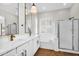 Bright primary bathroom featuring double sinks with quartz countertops, a soaking tub, and a glass shower at 4121 E Patrick St, Gilbert, AZ 85295