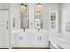 Luxurious bathroom with dual sinks, soaking tub, stylish fixtures, and ample storage at 4121 E Patrick St, Gilbert, AZ 85295