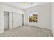Bright bedroom featuring gray carpeting, neutral paint, and a window view to the exterior landscaping at 4121 E Patrick St, Gilbert, AZ 85295