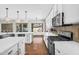 Gourmet kitchen with white cabinets, backsplash, stainless steel appliances, and ample counter space at 4121 E Patrick St, Gilbert, AZ 85295