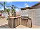 Outdoor kitchen features a built-in grill, mini fridge, and counter space for easy entertaining at 4121 E Patrick St, Gilbert, AZ 85295