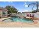 Inviting pool features unique rock formations and a cozy fire pit area with chairs at 4121 E Patrick St, Gilbert, AZ 85295