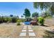 A backyard with an above-ground pool, a patio and beautiful landscaping at 4443 W Escuda Dr, Glendale, AZ 85308