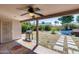 Covered patio with a grill overlooking a backyard with an above-ground pool and greenery at 4443 W Escuda Dr, Glendale, AZ 85308