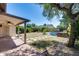 Backyard featuring a covered patio, an above-ground pool, and well-maintained greenery at 4443 W Escuda Dr, Glendale, AZ 85308
