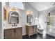 Bright bathroom featuring a dual vanity, modern lighting, and a black marble floor at 4443 W Escuda Dr, Glendale, AZ 85308