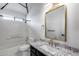 Updated bathroom featuring granite countertops, modern fixtures, and a shower-tub combo at 4443 W Escuda Dr, Glendale, AZ 85308