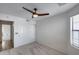 Comfortable bedroom with neutral carpet, closet, and bright window offering ample natural light at 4443 W Escuda Dr, Glendale, AZ 85308
