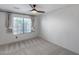 Bright bedroom with a ceiling fan and large window, offering natural light and comfort at 4443 W Escuda Dr, Glendale, AZ 85308