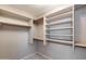 Walk-in closet featuring built-in shelving and ample storage space at 4443 W Escuda Dr, Glendale, AZ 85308