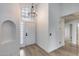 Bright foyer with arched window, chandelier, and neutral flooring creating an inviting entrance at 4443 W Escuda Dr, Glendale, AZ 85308