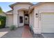 Charming front entrance with arched doorway, decorative wreath, and manicured landscaping at 4443 W Escuda Dr, Glendale, AZ 85308