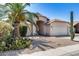 Inviting single-story home with desert landscaping, mature palm tree, and private two-car garage at 4443 W Escuda Dr, Glendale, AZ 85308