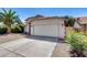 Front exterior showcasing a two-car garage, desert landscaping, and a well-maintained driveway at 4443 W Escuda Dr, Glendale, AZ 85308