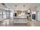 Bright kitchen featuring a large island, stainless steel appliances, and modern lighting fixtures at 4443 W Escuda Dr, Glendale, AZ 85308