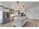 Well-lit kitchen with a large island, granite countertops, and stainless steel appliances at 4443 W Escuda Dr, Glendale, AZ 85308