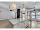 Kitchen with a large island, granite countertops, and natural lighting at 4443 W Escuda Dr, Glendale, AZ 85308