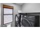 Laundry room with a window and modern machines at 4443 W Escuda Dr, Glendale, AZ 85308