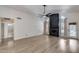 Bright open-concept living room with vaulted ceilings, sleek fireplace, and wood-look floors at 4443 W Escuda Dr, Glendale, AZ 85308