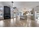 Bright open-concept living room with vaulted ceilings and sleek fireplace connecting to the kitchen at 4443 W Escuda Dr, Glendale, AZ 85308