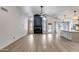 Open-concept living room with vaulted ceilings, modern fireplace, and wood-look floors at 4443 W Escuda Dr, Glendale, AZ 85308