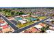 Aerial view of the community recreation center featuring tennis courts, a pool, and well-maintained green spaces at 4501 E Carol Ave # 77, Mesa, AZ 85206
