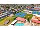 An aerial view showcasing community amenities including tennis courts and a swimming pool at 4501 E Carol Ave # 77, Mesa, AZ 85206