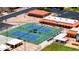 Aerial view of two pristine tennis courts surrounded by well-manicured landscaping, offering a vibrant recreational setting at 4501 E Carol Ave # 77, Mesa, AZ 85206