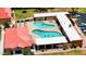 Aerial view showcasing a community pool and hot tub surrounded by manicured lawns and lounge chairs at 4501 E Carol Ave # 77, Mesa, AZ 85206