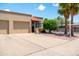 Charming home featuring a two-car garage and landscaped front yard with mature palm trees under a clear blue sky at 4501 E Carol Ave # 77, Mesa, AZ 85206
