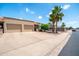 Charming exterior showcasing mature palm trees and an oversized two-car garage at 4501 E Carol Ave # 77, Mesa, AZ 85206
