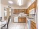 Open kitchen offers bright light, white appliances, and oak cabinetry at 4501 E Carol Ave # 77, Mesa, AZ 85206