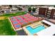 An overhead view of pickleball courts adjacent to a pool and sunbathing area at 4501 E Carol Ave # 77, Mesa, AZ 85206