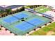 Aerial shot of well-maintained tennis courts with green surroundings and spectator seating at 4501 E Carol Ave # 77, Mesa, AZ 85206
